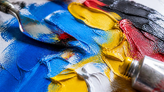 Extreme macro of thick oil-paint impasto ridges and swirls in vivid pop-art colours with a palette knife and paint tube in dr