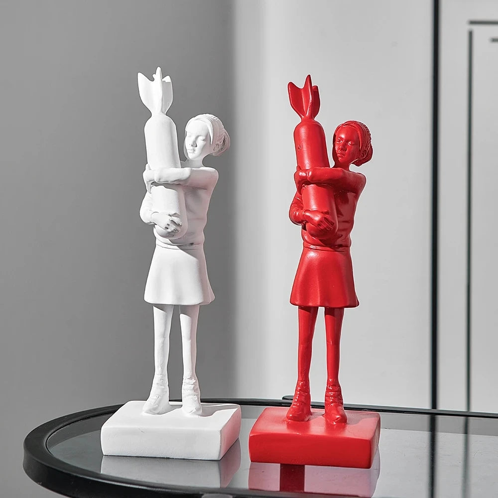 Resin Banksy Hugging Bomb Girl sculpture, capturing the essence of urban street art in red and white