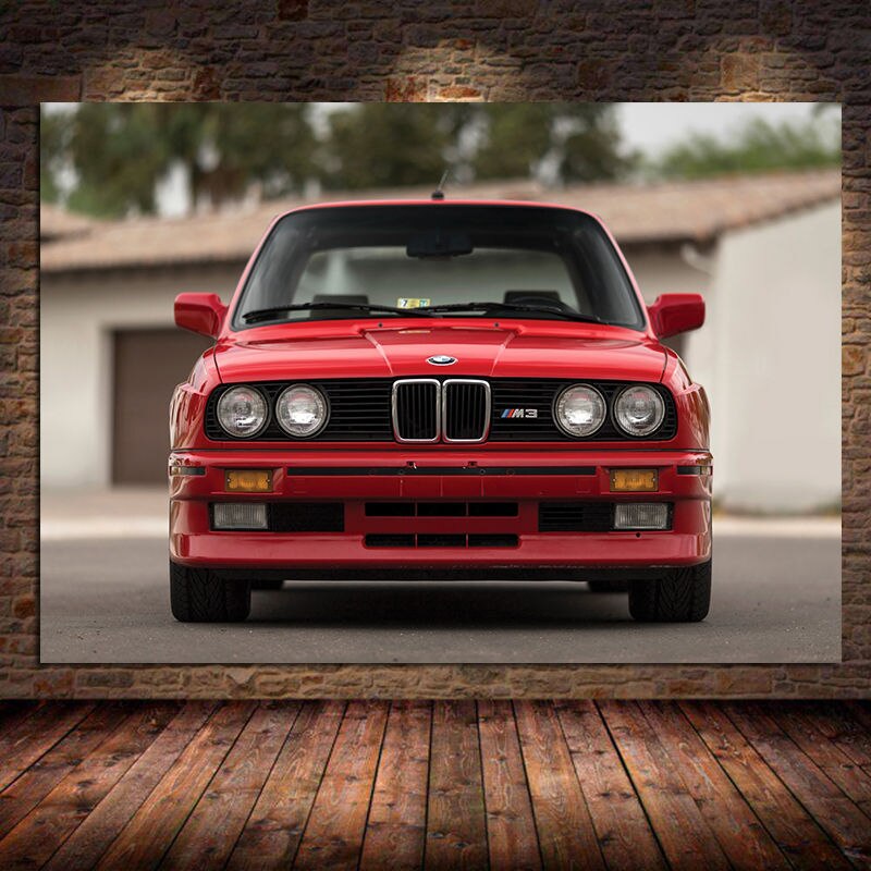 A classic BMW M3 E30 painted in a vibrant shade of red